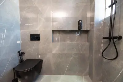 a bathroom with a toilet and a shower at Eleni's Cozy Apartments Near Athens Airport By SEM in Koropíon