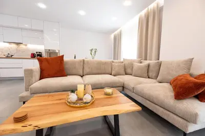 a living room with a couch and a table at Eleni's Cozy Apartments Near Athens Airport By SEM in Koropíon