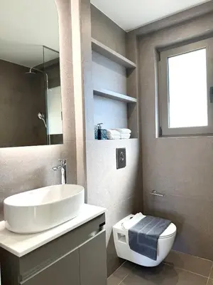 a bathroom with a sink and a toilet and a window at M58 Pool Residence - Glyfada Central - Miltiadou 58 by K&M in Athens