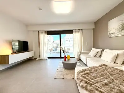 a large living room with a couch and a tv at M58 Pool Residence - Glyfada Central - Miltiadou 58 by K&M in Athens