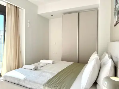 a bedroom with a bed and a large window at M58 Pool Residence - Glyfada Central - Miltiadou 58 by K&M in Athens