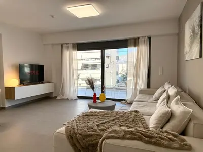 a living room with a couch and a tv at M58 Pool Residence - Glyfada Central - Miltiadou 58 by K&M in Athens