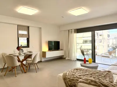 a living room with a couch and a table and a television at M58 Pool Residence - Glyfada Central - Miltiadou 58 by K&M in Athens