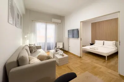 a living room with a couch and a bed at Casa Bianca in Pagrati in Athens