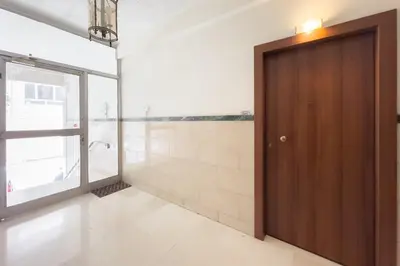 a bathroom with a wooden door and a window at Casa Bianca in Pagrati in Athens