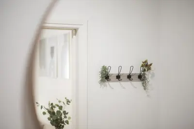 a door with a window and a shelf with plants at Casa Bianca in Pagrati in Athens