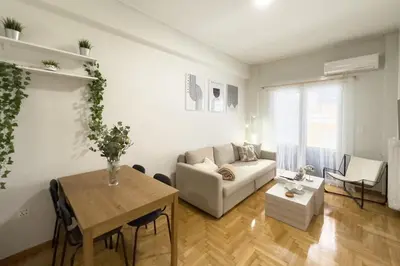a living room with a couch and a table at Casa Bianca in Pagrati in Athens