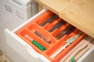 an orange tray filled with utensils in a drawer at Casa Bianca in Pagrati in Athens