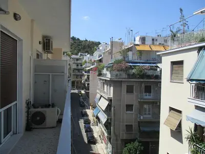 an apartment balcony with a view of a city at Sharing can change the world! in Athens
