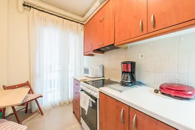a kitchen with a stove and a microwave at Heart of Athens Stay Apartment in Athens