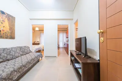 a living room with a couch and a tv at Heart of Athens Stay Apartment in Athens