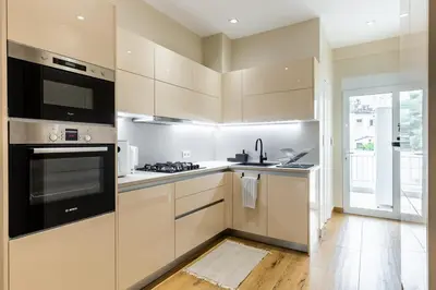 a kitchen with white cabinets and a stove top oven at The Sea Breeze, Glyfada in Athens