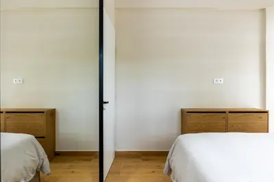 two beds in a room with white walls at The Sea Breeze, Glyfada in Athens