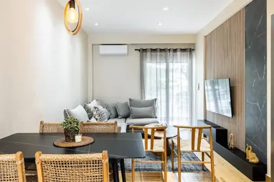 a living room with a table and a couch at The Sea Breeze, Glyfada in Athens