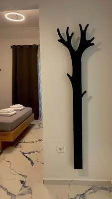 a wall with a silhouette of a tree on a wall at LuxBlue Apartment Kypseli in Athens