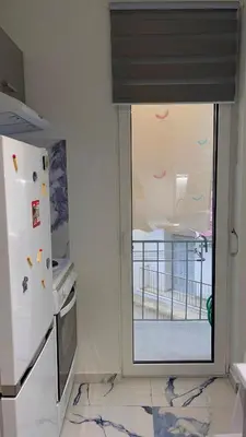 a kitchen with a window with a view of a balcony at LuxBlue Apartment Kypseli in Athens