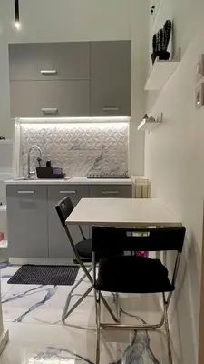 a kitchen with a table and a sink at LuxBlue Apartment Kypseli in Athens