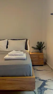 a bedroom with a bed with two towels on it at LuxBlue Apartment Kypseli in Athens
