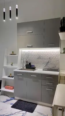 a kitchen with white cabinets and a sink at LuxBlue Apartment Kypseli in Athens