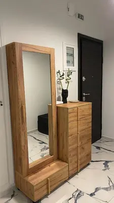 a mirror sitting on top of a wooden dresser at LuxBlue Apartment Kypseli in Athens