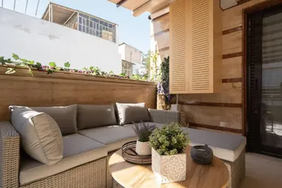 a patio with a couch and a table at 3BR Private House with 3 Bathrooms & Amazing Balcony in Athens