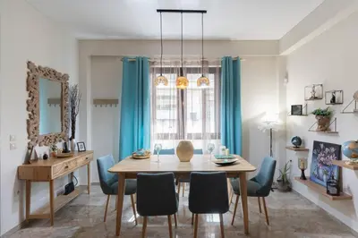 a dining room with a table and blue chairs at 3BR Private House with 3 Bathrooms & Amazing Balcony in Athens