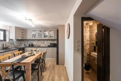 a kitchen and dining room with a wooden table and chairs at 3BR Private House with 3 Bathrooms & Amazing Balcony in Athens