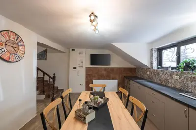 a kitchen and dining room with a table and chairs at 3BR Private House with 3 Bathrooms & Amazing Balcony in Athens