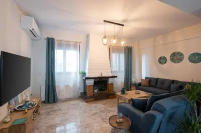 a living room with a couch and a fireplace at 3BR Private House with 3 Bathrooms & Amazing Balcony in Athens