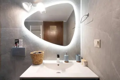 a bathroom with a sink and a mirror at 3BR Private House with 3 Bathrooms & Amazing Balcony in Athens