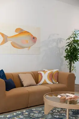 a living room with a brown couch and a table at 1BR Designer Apt Next To Metro & 15 minutes to Acropolis in Athens