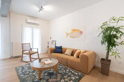 a living room with a couch and a table at 1BR Designer Apt Next To Metro & 15 minutes to Acropolis in Athens