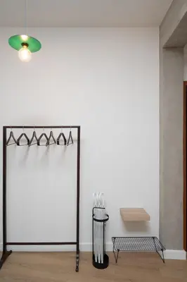a room with a white wall and a table at 1BR Designer Apt Next To Metro & 15 minutes to Acropolis in Athens