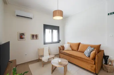 a living room with a couch and a table at 1BR Cozy Apt Near Metro with Huge Balcony &City View in Athens