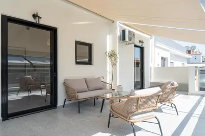 a living room with a glass table and chairs at 1BR Cozy Apt Near Metro with Huge Balcony &City View in Athens