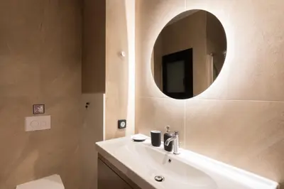 a bathroom with a sink and a mirror on the wall at 2BR Apartment, Access to Rooftop Retreat with Sauna & Jacuzzi in Athens