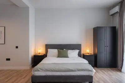 a bedroom with a large bed with two night stands at 2BR Apartment, Access to Rooftop Retreat with Sauna & Jacuzzi in Athens