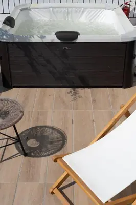 a hot tub with a table and a white table at Modern 2BR with Rooftop Jacuzzi & Sauna Access in Athens