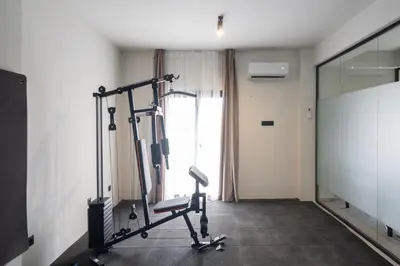 a room with a gym with a treadmill at Modern 2BR with Rooftop Jacuzzi & Sauna Access in Athens
