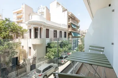a balcony with a bench and a street at Modern 2BR with Rooftop Jacuzzi & Sauna Access in Athens