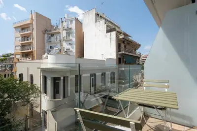 a balcony with a bench and some buildings at Stylish 2BR Apt, Rooftop with Sauna & Hot Tub in Athens