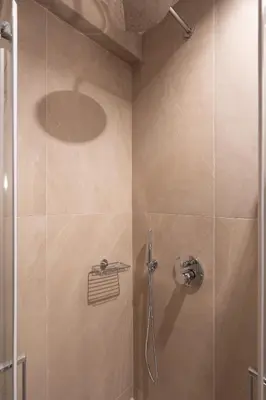 a bathroom with a shower with a glass door at 2BR Apt Access To Rooftop with Sauna & Jacuzzi in Athens