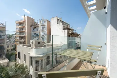 a balcony with a bench and some buildings at 2BR Apt Access To Rooftop with Sauna & Jacuzzi in Athens