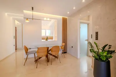a kitchen and dining room with a table and chairs at Azure7 Seaside - Luxury Apartment in Varkiza in Varkiza