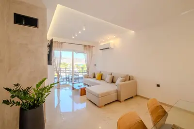 a living room with a couch and a table at Azure7 Seaside - Luxury Apartment in Varkiza in Varkiza