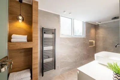 a bathroom with a towel shelf and a sink at Azure7 Seaside - Luxury Apartment in Varkiza in Varkiza
