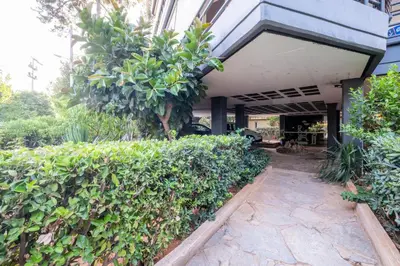 an entrance to a building with bushes and trees at Azure7 Seaside - Luxury Apartment in Varkiza in Varkiza