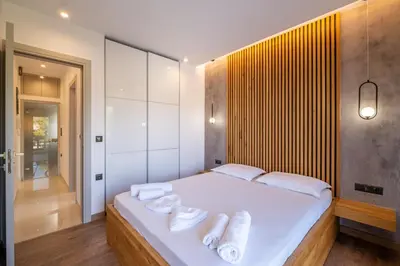 a bedroom with a white bed with towels on it at Azure7 Seaside - Luxury Apartment in Varkiza in Varkiza