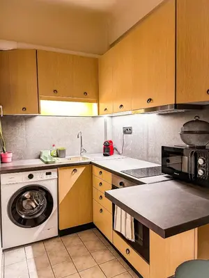 a kitchen with a washing machine and a washer at The North Nest in Athens