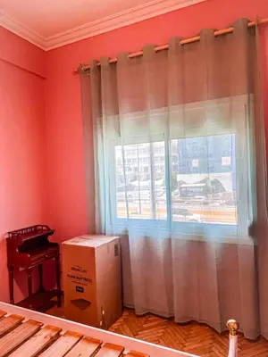 a living room with a window and a box at The North Nest in Athens